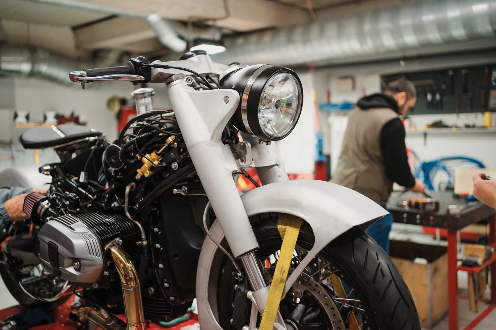 custom motorcycle standing repair shop scaled