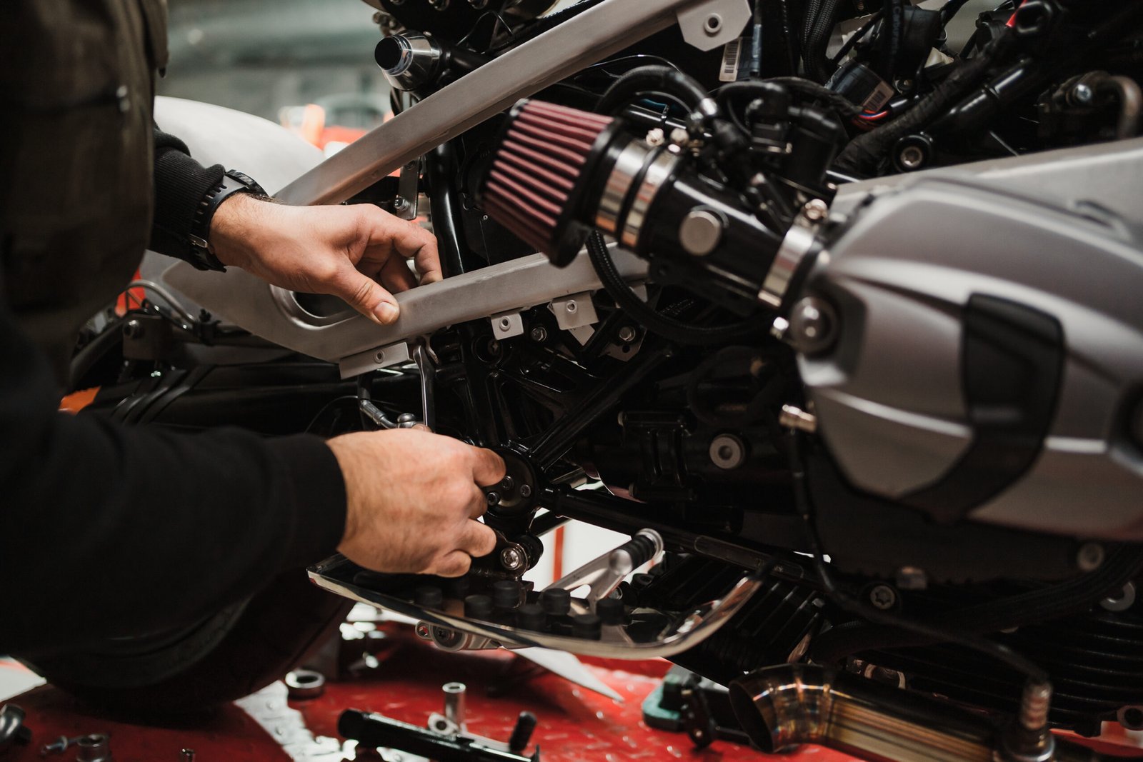 man fixing motorcycle modern workshop 1 1 scaled
