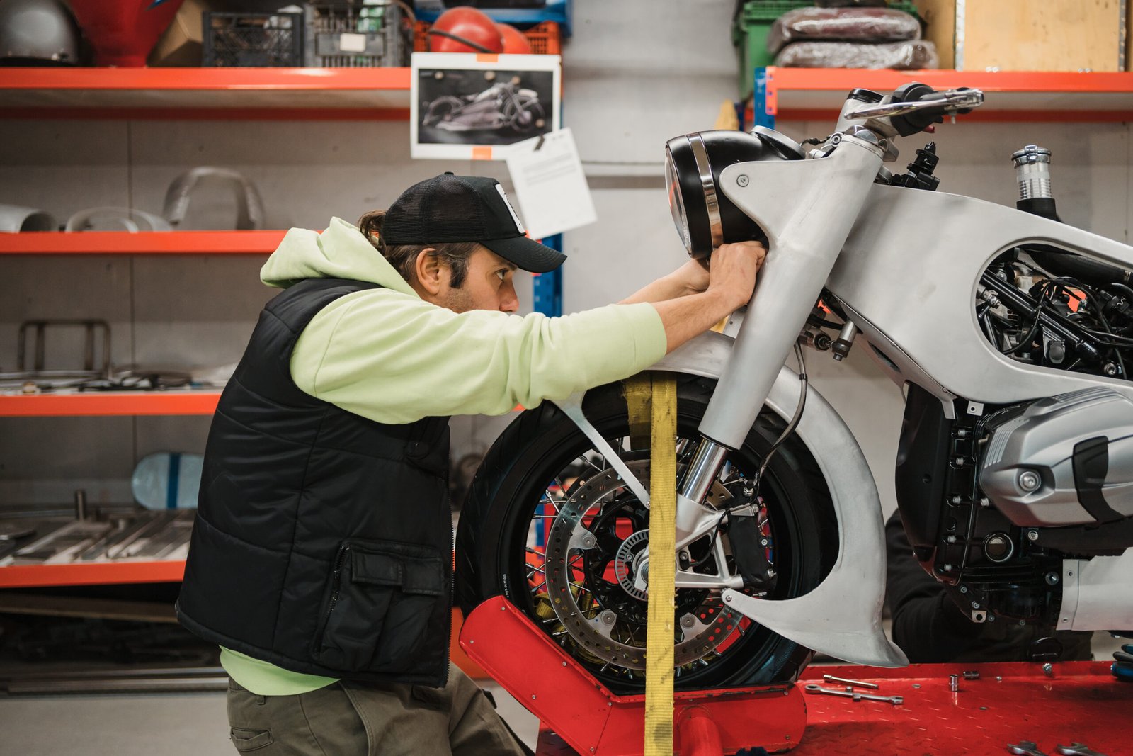 man fixing motorcycle modern workshop 3 scaled